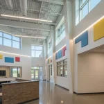 Bright modern school interior with open, colorful spaces.
